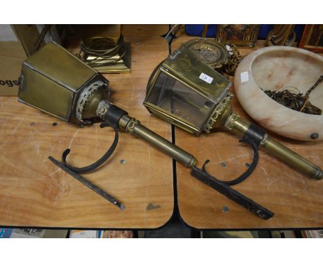 A pair of coaching lamps style light fittings.