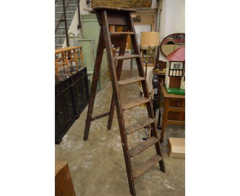 An old pair of Stephens and Carter wooden step ladders, broad arrow mark and G R ciphers.