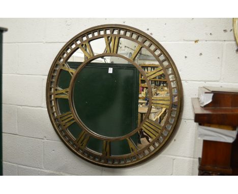 A metal clock face circular mirror.
