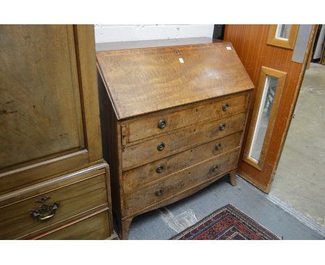 A good George III 'plum pudding' mahogany bureau with fall flap enclosing a fitted interior above four graduated long drawers