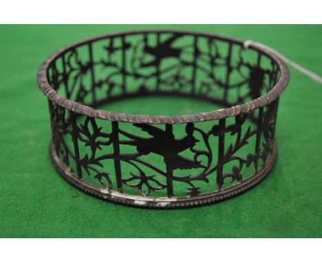 A small silver dish ring with pierced decoration together with a Continental silver dish with embossed decoration.