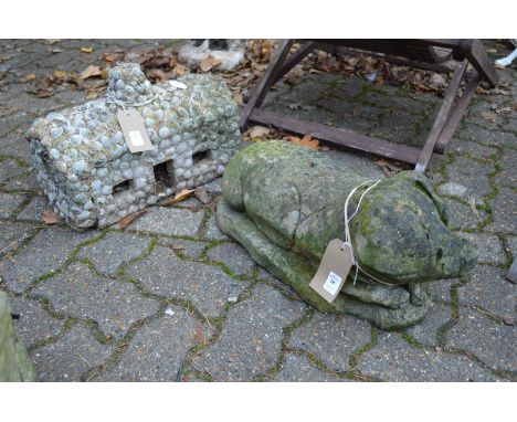 Garden ornament modelled as a pig together with another item.