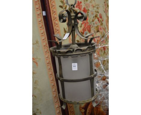 A brass and frosted glass hall lantern.