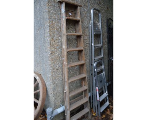A wooden step ladder and two aluminium step ladders.