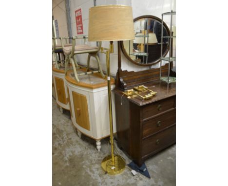 A brass floor standing adjustable lamp and pair of similar wall lights.