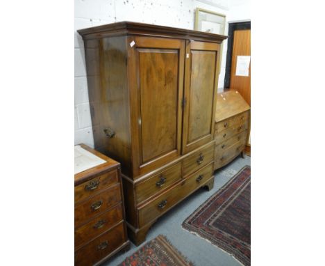 A George III mahogany linen press with pair of panel doors enclosing five sliding shelves, the base with two short and one lo