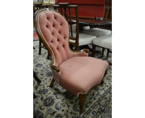 A button upholstered bedroom chair.