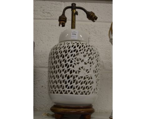 A Chinese blanc de chine lamp base with pierced decoration.