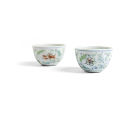 PAIR OF DOUCAI 'FLOWER' CUPS KANGXI MARK BUT 19TH CENTURY each delicately potted, enamelled on the tapered body with floral a