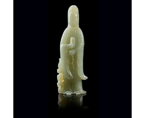 PALE CELADON JADE CARVING OF GUANYIN QING DYNASTY, 19TH CENTURY carved in round with a standing Guanyin Avalokitesvara dressi