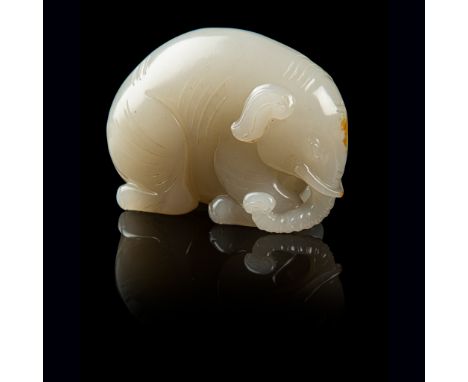 WHITE JADE CARVING OF AN ELEPHANT QING DYNASTY, 19TH CENTURY finely rendered in round as an arched-back recumbent elephant wi