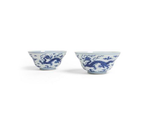 PAIR OF BLUE AND WHITE 'DRAGON' BOWLS DAOGUANG MARK AND OF THE PERIOD each thinly potted on a short ring foot, rising to roun