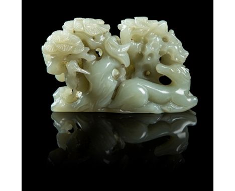 CELADON JADE 'DEER AND CRANE' BRUSH REST QING DYNASTY, 18TH CENTURY carved as a boulder with openwork rocks and dense pine tr