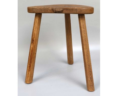 Workshop of Robert Mouseman Thompson (Kilburn): An English Oak Cow Stool, the kidney shaped seat on three octagonal legs, wit