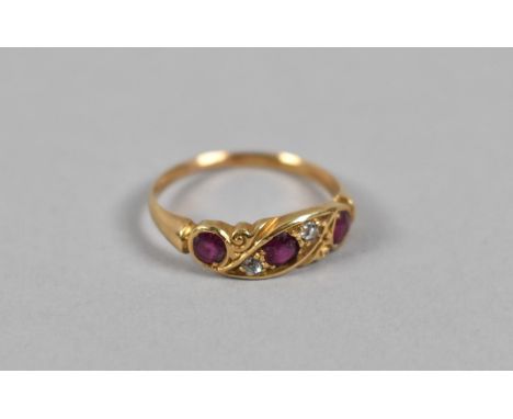 An 18ct Gold Dress Ring Set with Three Rubies and Two Diamond Chips 