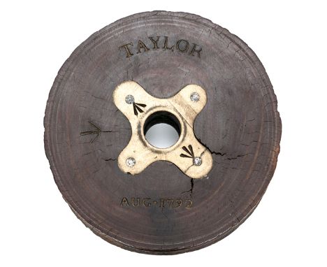 A naval pulley sheave of lignum vitae, brass mounted central hole for axle stamped with broad arrows, the wood also marked wi