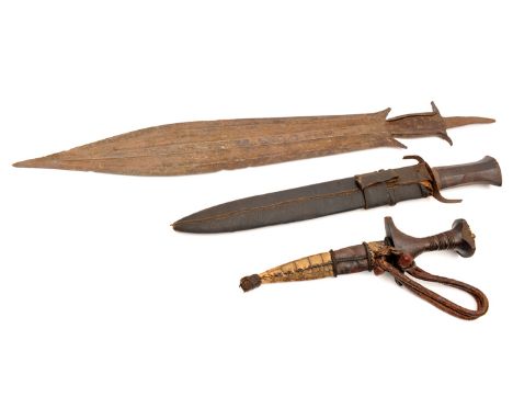A central African knife or short sword, the broad leaf shaped blade 19” with central ridge and hatched decoration, the hilt e