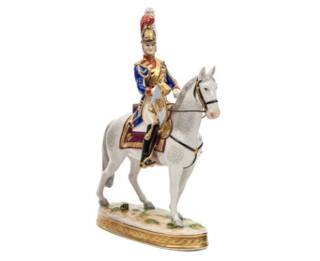 A painted porcelain mounted figure of a French “Trompeter 1814/15”, in full dress, with trumpet and banner, shabraque, on ova