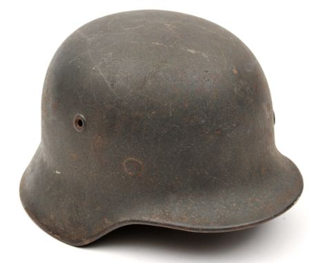 A Third Reich M40 steel helmet, with dark grey finish and single Luftwaffe eagle decal, stamped “ET 62” (Eisenhuttenwerke, Th