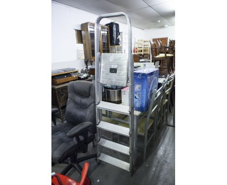 A REVOLVING OFFICE CHAIR WITH RED MOULDED PLASTIC SEAT AND AN ELECTRIC CABLE ON REEL AND A SET OF STEP LADDERS 