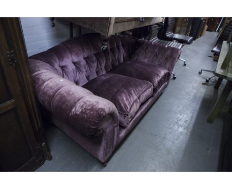 LIBERTY LONDON SOFA UPHOLSTERED IN PURPLE VELVET WITH BUTTON BACK AND ARMS, STUFF OVER SEAT CUSHIONS, ALL RAISED ON BUN SUPPO