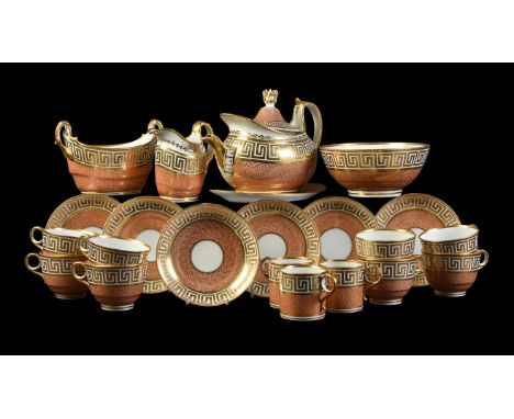 A Worcester (Barr) part tea service, circa 1800, decorated with a gilt Greek key band above a salmon-pink vermicular ground, 