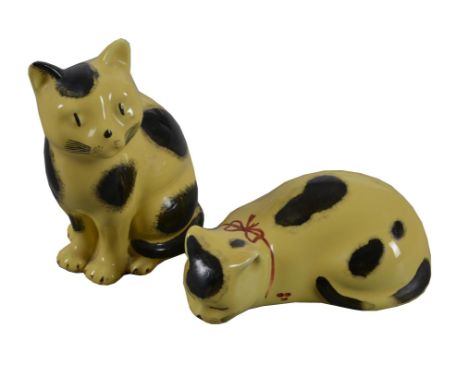 λ Piero Fornasetti, a pair of ceramic cats, in yellow and black colourway, one modelled standing the other prone, 11cm high, 