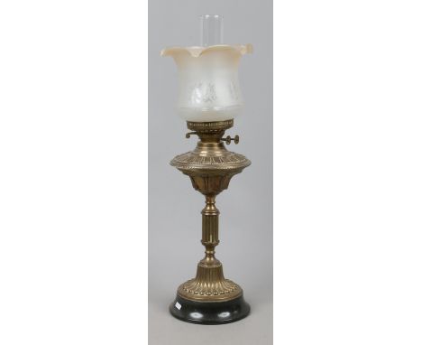 A Victorian brass based oil lamp with frosted glass shade.