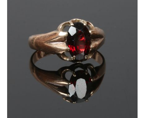 A George V 9ct gold ring set with a large claw set garnet, assayed Birmingham 1916, size R.