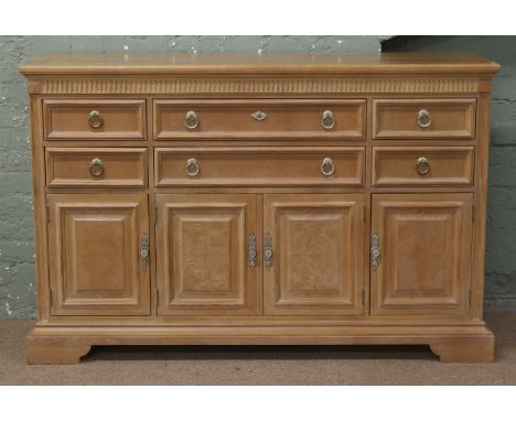 A Stanley furniture limed oak sideboard with panelled doors and raised on bracket feet, 1m 57cm wide, 1m 2cm high, 48 deep.