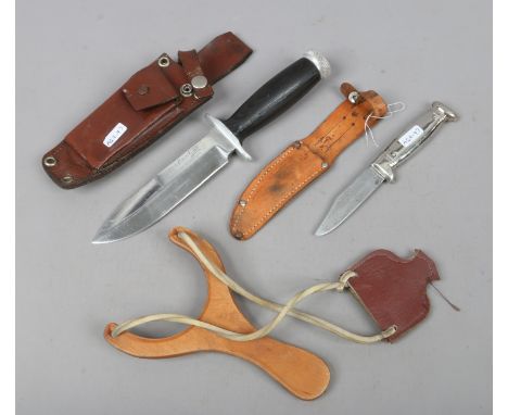 A Herbertz survival knife along with a Richards hunting knife and catapult.