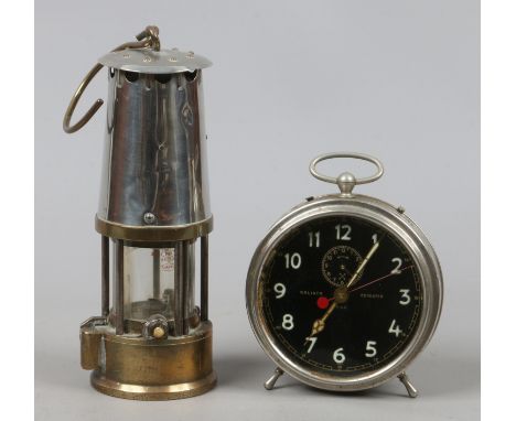 A brass miners lamp along with a H.A.C Goliath repeater clock.
