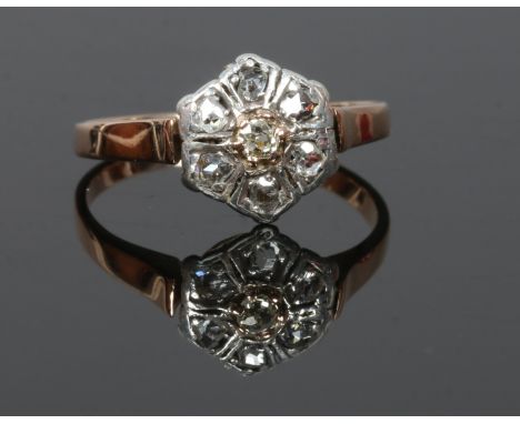 A gold diamond cluster ring set with seven old cut stones, size O.