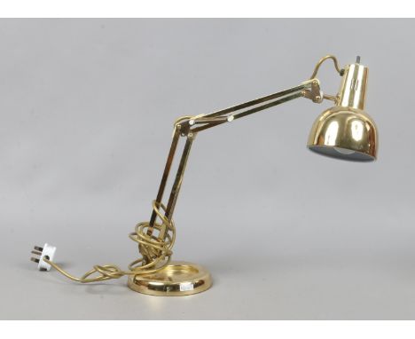 A brass effect anglepoise desk lamp.