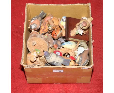 A box of ceramic figures of birds.