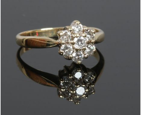 An 18ct gold diamond cluster ring set with seven stones, size N.