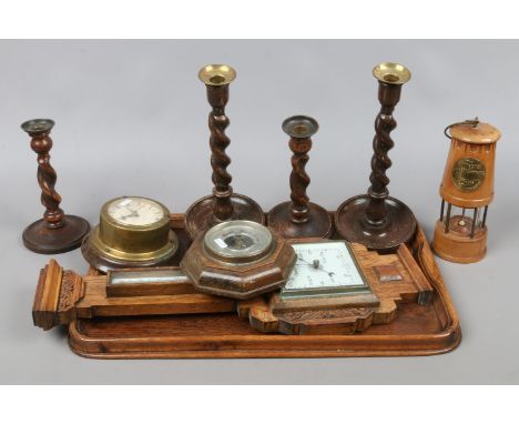 An oak serving tray, two pairs of barleytwist candlesticks, barometers and a wooden model of a miners lamp.