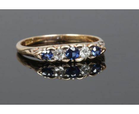 An early 20th century 18ct gold sapphire and diamond five stone ring, size O.