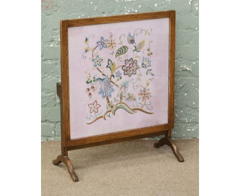 A metamorphic oak framed silkwork firescreen / occasional table.