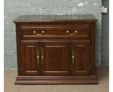 A panelled mahogany buffet sideboard with fold out serving top.