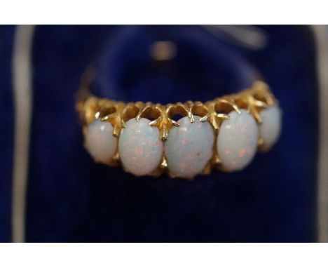 Gold 5 stone opal ring, hallmarked rubbed, set with 5 good quality opals Size M.5