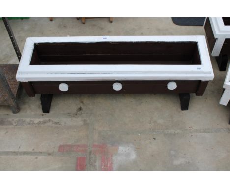 A WOODEN TROUGH PLANTER 