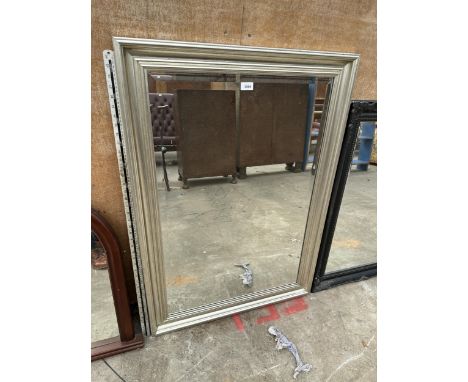 A RECTANGULAR SILVER GILT BEVEL EDGED MIRROR 