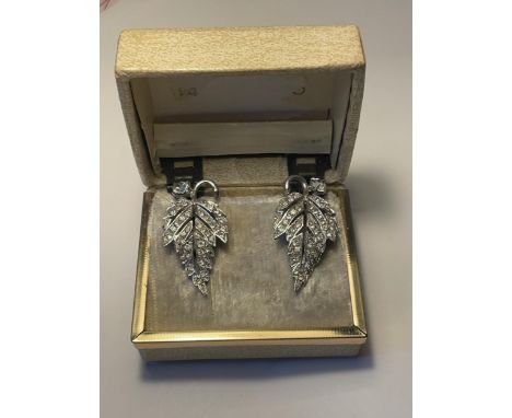 A PAIR OF 1040'S METAL RHODIUM AND CLEAR STONE EARRINGS IN A LEAF DESIGN WITH PRESENTATION BOX 