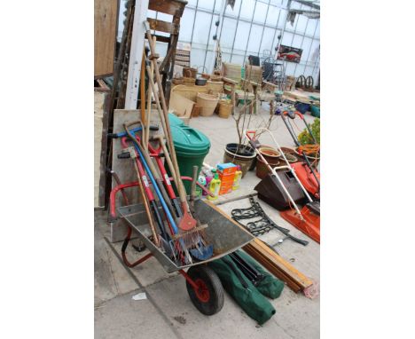A METAL WHEEL BARROW, AN ASSORTMENT OF GARDEN TOOLS AND A PIECE OF MARBLE 
