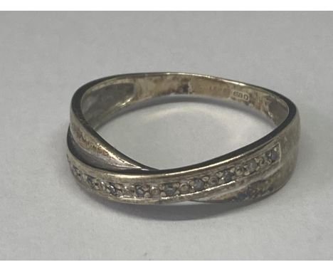 A 9 CARAT GOLD CROSSOVER RING WITH DIAMONDS SIZE K/L 