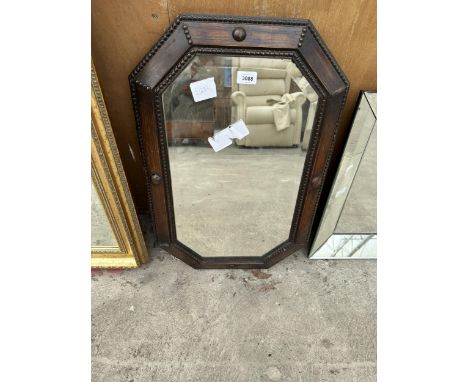 AN OAK FRAMED OCTAGONAL MIRROR 