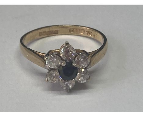 A 9 CARAT GOLD RING WITH A SAPPHIRE SURROUNDED BY CUBIC ZIRCONIAS SIZE N 