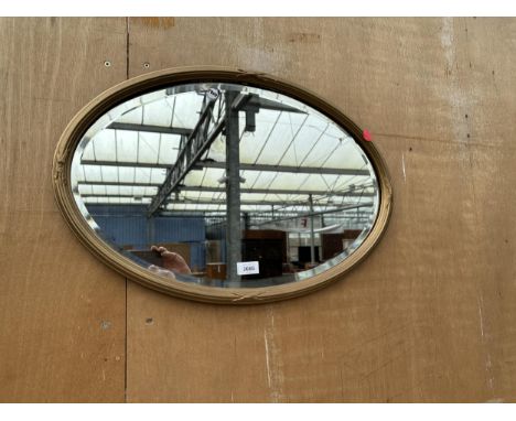 AN OVAL BEVEL EDGE WALL MIRROR, 25" X 17" 