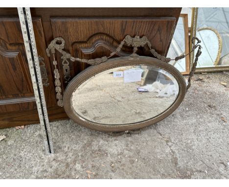 AN ORNATE OVAL MIRROR (FRAME A/F) 